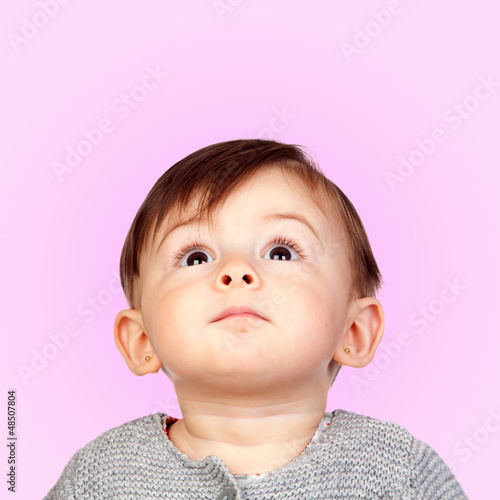 Photo: Surprised baby girl looking up Surprised baby girl looking up