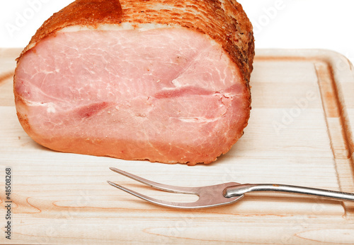 Photo: Ham on Carving Board with Serving Fork Ham on Carving Board with Serving Fork