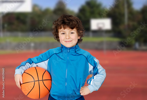 Photo: Adorable child playing the basketball Adorable child playing the basketball