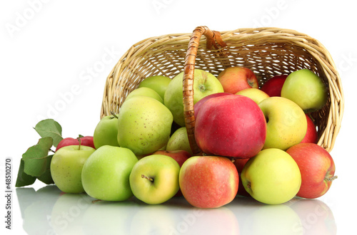 Photo: juicy apples with green leaves in basket, isolated on white juicy apples with green leaves in basket, isolated on white