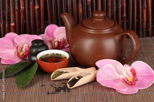 Photo: Chinese tea ceremony on bamboo table on bamboo background Chinese tea ceremony on bamboo table on bamboo background