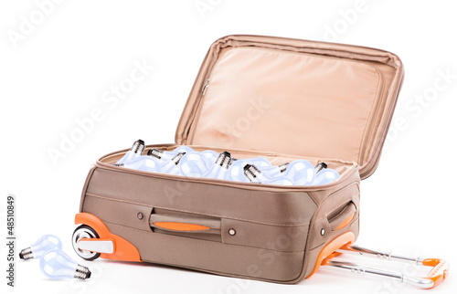 Photo: Suitcase and light bulb isolated on a white background Suitcase and light bulb isolated on a white background