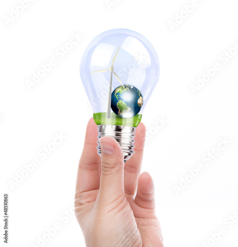 Photo: Hand holding light bulb with wind turbine and earth inside (Elem Hand holding light bulb with wind turbine and earth inside (Elem