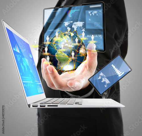 Photo: Business man with laptop,mobile phone,touch screen device (Eleme Business man with laptop,mobile phone,touch screen device (Eleme