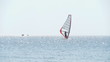 windsurfer against a sparking blue sea