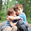Photo: Two brothers hugging in park Two brothers hugging in park