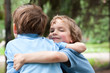 Photo: Two brothers hugging in park Two brothers hugging in park