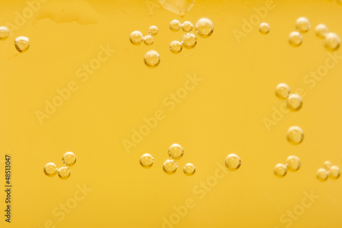 Photo: background of yellow beer. macro background of yellow beer. macro