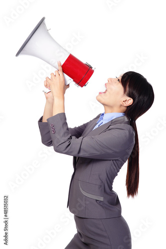 Photo: Business woman screaming in megaphone Business woman screaming in megaphone