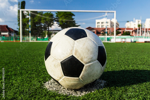 Photo: soccer ball on green grass in front of goal net soccer ball on green grass in front of goal net