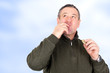 Man eating cookies and licks his fingers