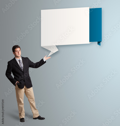 Photo: attractive man presenting modern origami copy space attractive man presenting modern origami copy space