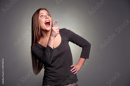 Photo: amazed woman laughing and pointing up amazed woman laughing and pointing up