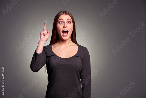 Photo: amazed young woman pointing upward amazed young woman pointing upward