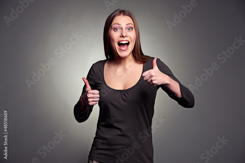 Photo: excited woman showing thumbs up excited woman showing thumbs up