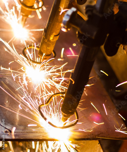 Photo: CNC LPG cutting with sparks close up CNC LPG cutting with sparks close up