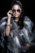 Pretty woman wearing sunglasses and beautiful fur