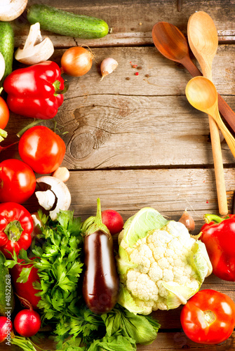Photo: Healthy Organic Vegetables on a Wood Background Healthy Organic Vegetables on a Wood Background