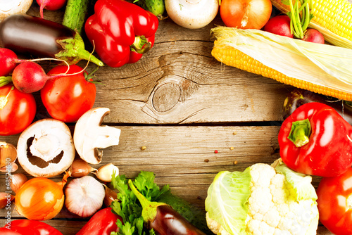 Photo: Healthy Organic Vegetables on the Wooden Background Healthy Organic Vegetables on the Wooden Background