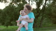 Happy mother playing with baby outdoor