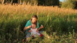 Mother with baby blows soap bubbles