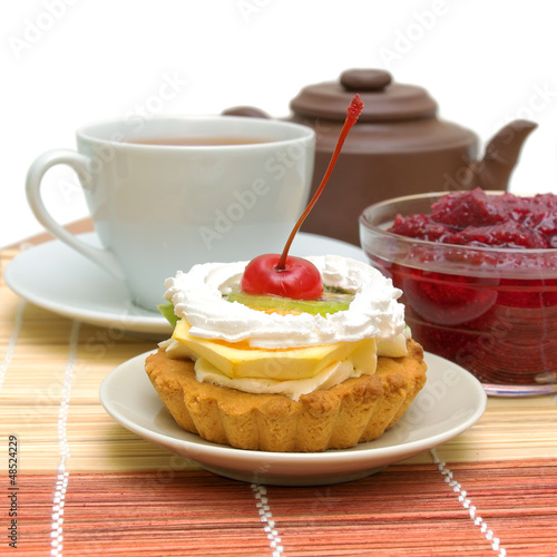 Photo: fruit cake against a cup of tea and jam fruit cake against a cup of tea and jam