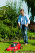 Man is mowing the lawn in summer