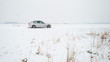 Car Parked On A Snowy Road
