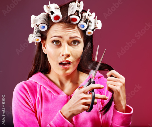 Photo: Woman wear hair curlers on head. Woman wear hair curlers on head.