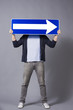 Man holding horizontal direction arrow sign.