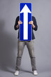 Photo: Man holding vertical direction arrow sign. Man holding vertical direction arrow sign.