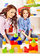 Photo: Family with child playing bricks. Family with child playing bricks.