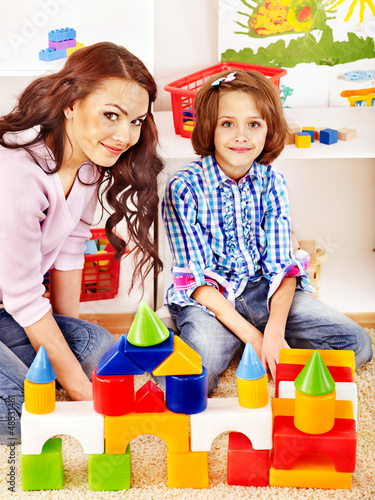 Photo: Family with child playing bricks. Family with child playing bricks.