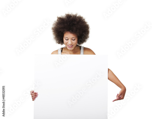Photo: Woman holding a white billboard Woman holding a white billboard