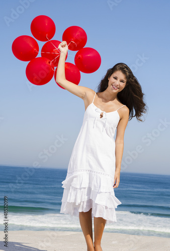 Photo: Beautiful girl holding red ballons Beautiful girl holding red ballons