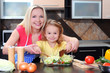 Mother and daughter cooking dinner in kitchen