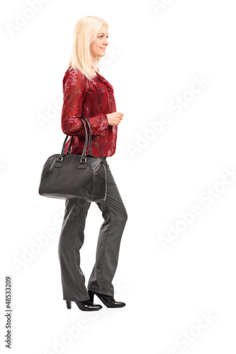 Photo: Full length portrait of a blond woman standing in profile Full length portrait of a blond woman standing in profile