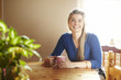 Young woman sitting at table smiling