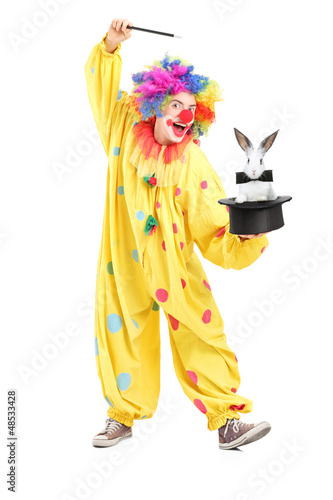 Photo: Circus clown performing a magic trick with a top hat and a rabbi Circus clown performing a magic trick with a top hat and a rabbi