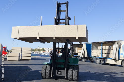 Photo: Green fork lifter truck and cargo box Green fork lifter truck and cargo box