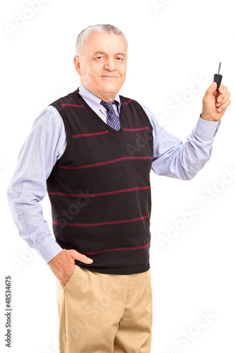 Photo: Satisfied mature man holding a car key Satisfied mature man holding a car key