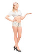 Full length portrait of a young female in short pants gesturing