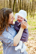Young mother with little baby daughter in park