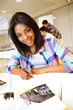 Portrait of student girl writing on notebook