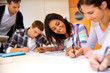 Group of teenagers in class writing an exam