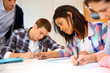 Group of teenagers in class writing an exam