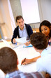 Teacher giving business presentation to students