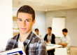 Student boy in class holding books