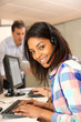 Portrait of cheerful young woman with headset on