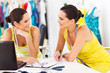 two happy fashion designers discussing new design in studio
